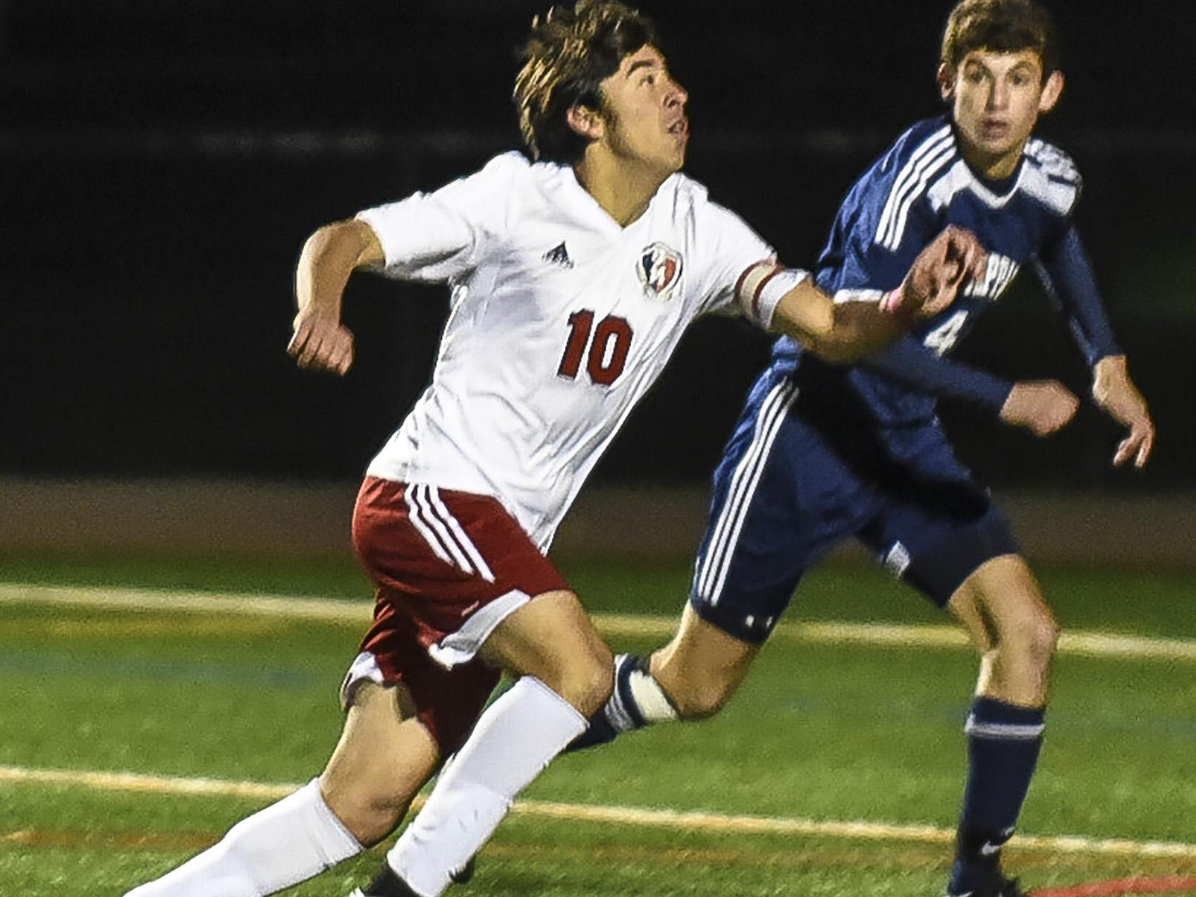 Mendham's Christian Pedercini (10) heads the ball away from Old Tappan's Luois Long (4) in the NJSIAA Group III Semifinal at Ridge High School in Basking Ridge, November 17, 2015. Photo by Warren Wetura for the Daily Record.