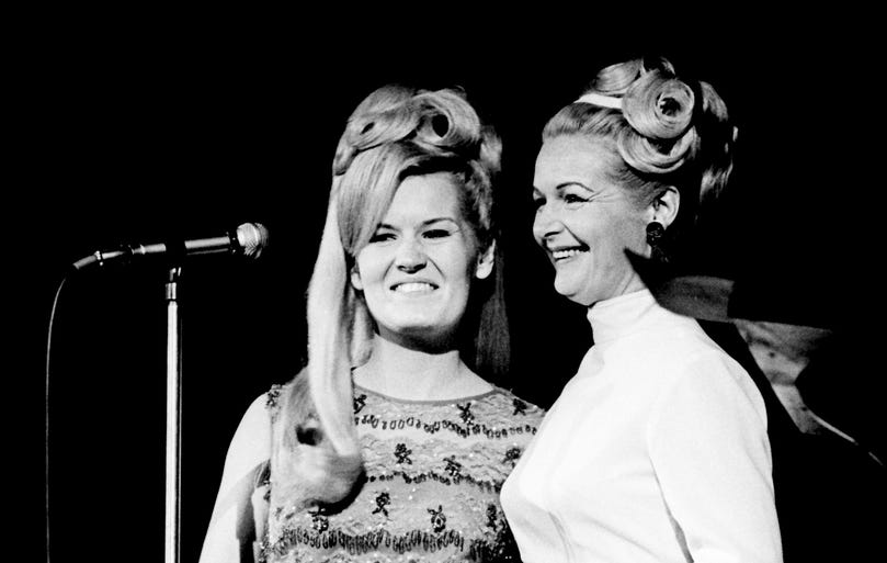 Lynn Anderson, left, and her mother, Liz Anderson, stand before the microphone at RCA Victor's Opry breakfast Oct. 22, 1967. Singer and writer Liz Anderson told the audience she wasn't going to sing, but just wanted to introduce her daughter, who appears on "The Lawrence Welk Show."