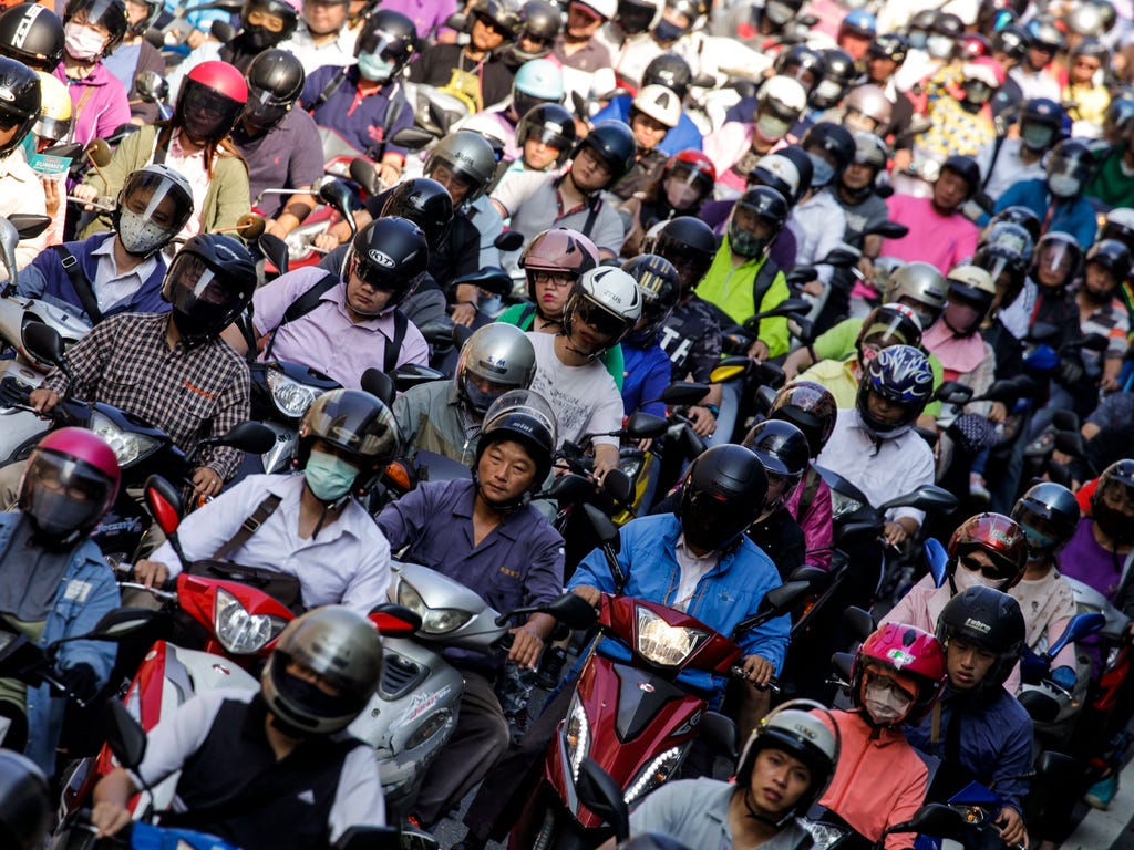 Motorists traverse on a busy street during rush hour in Taipei, Taiwan, July 11, 2017. The United Nations Population Fund (UNFPA) celebrates World Population Day on July 11, which highlights how family planning can empower people and help developing 