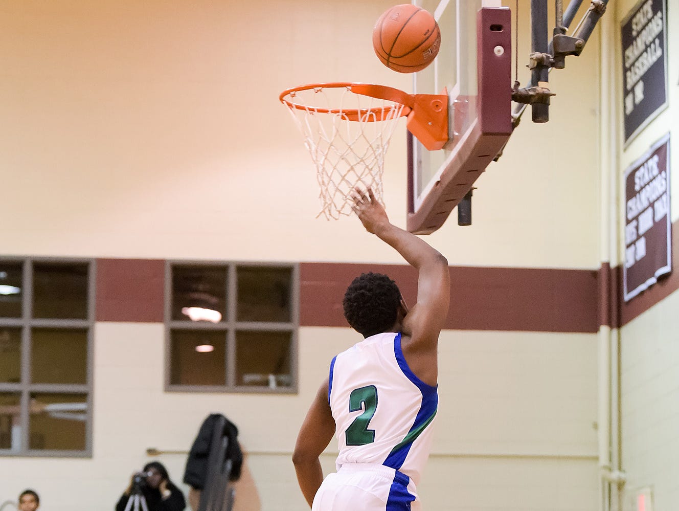 Kyson Rawls (No. 2) of St. Georges Technical High School takes the ball to the net.