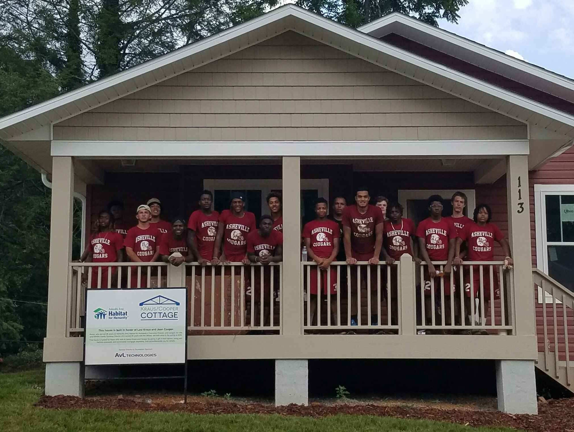 Asheville High football players volunteered their time Saturday for two local charities — Habitat for Humanity and MANNA FoodBank.