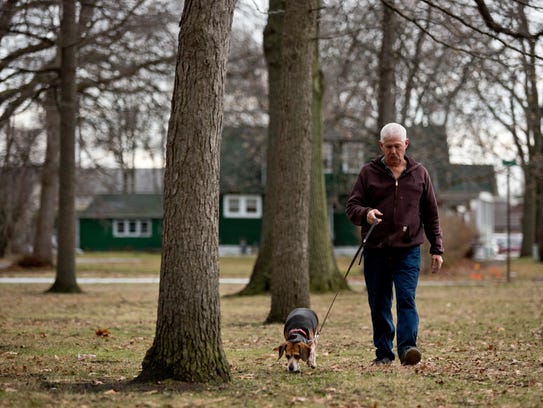 Bill Kessler walks his five-year-old Beagle, Daisy,