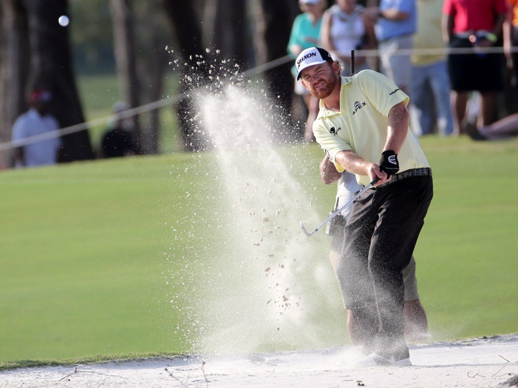 J.B. Holmes hits from the sand on the 16th hole during the third round of The Players Championship at TPC Sawgrass - Stadium Course.