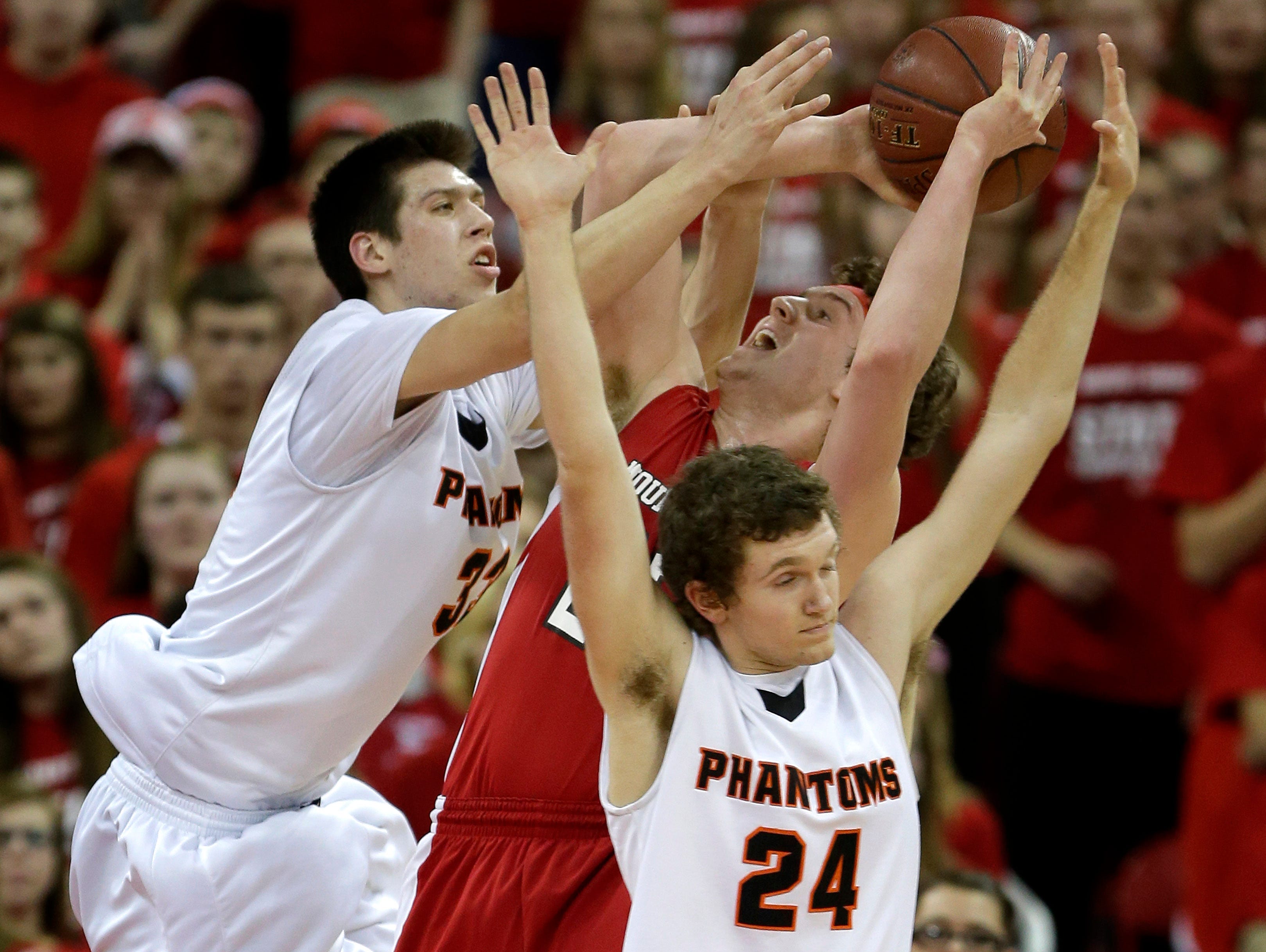 West De Pere High School's #33 Cody Schwartz and #24 Cole Kempen defend against Mount Horeb High School's #24 Nathaniel Osterloo during their Division 2 semifinal basketball game in the 100th annual WIAA State Boys Basketball Tournament at the Kohl Center on March 20, 2015, in Madison, Wis. Wm.Glasheen/Post-Crescent Media