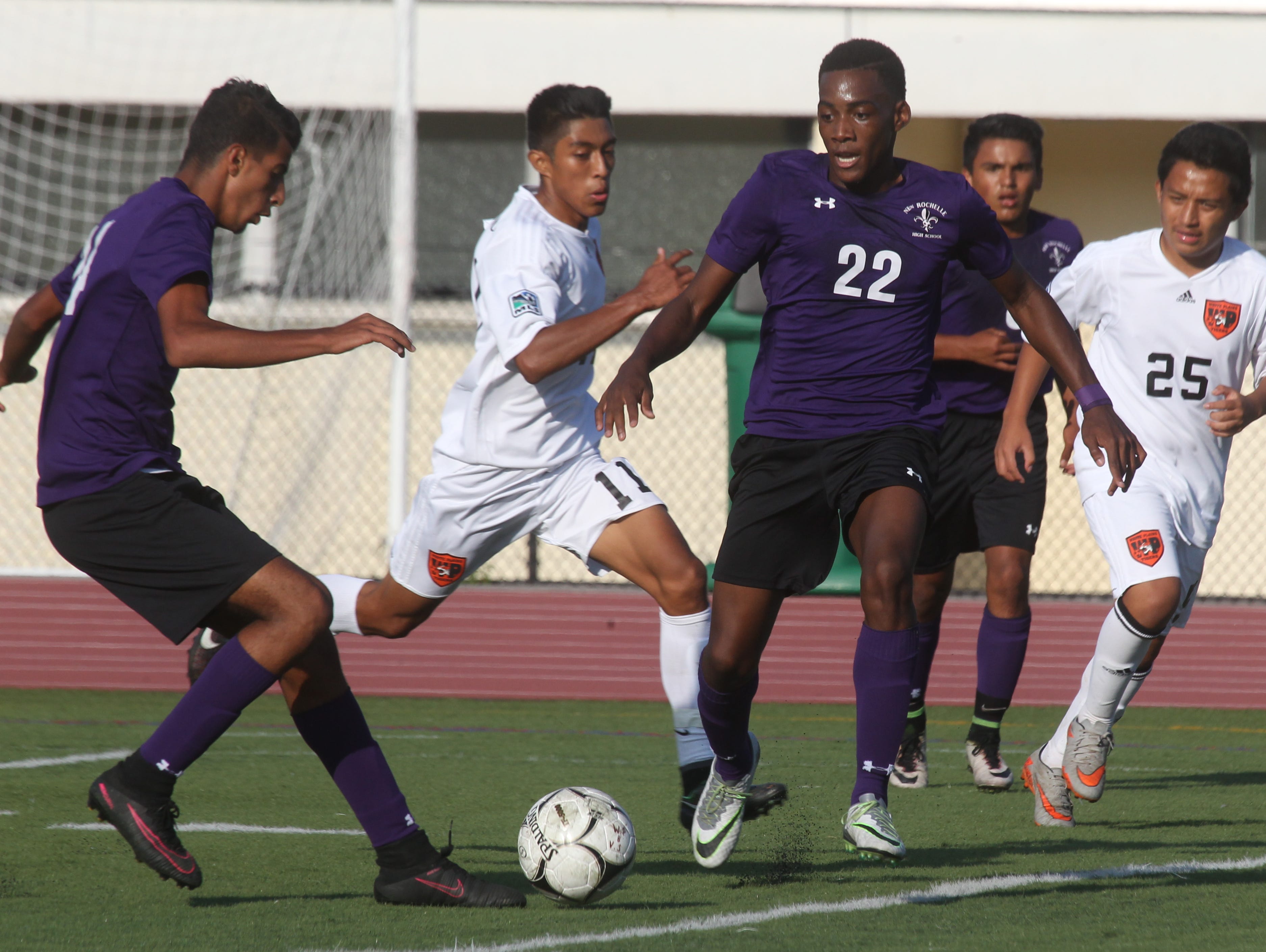 New Rochelle's Harwan Alzuabidi, left, and Tremaine Bryant (22) are pressured by White Plains' Levin Gramajio (11) during their game at White Plains Sept. 26, 2016. New Rochelle won 2-0.