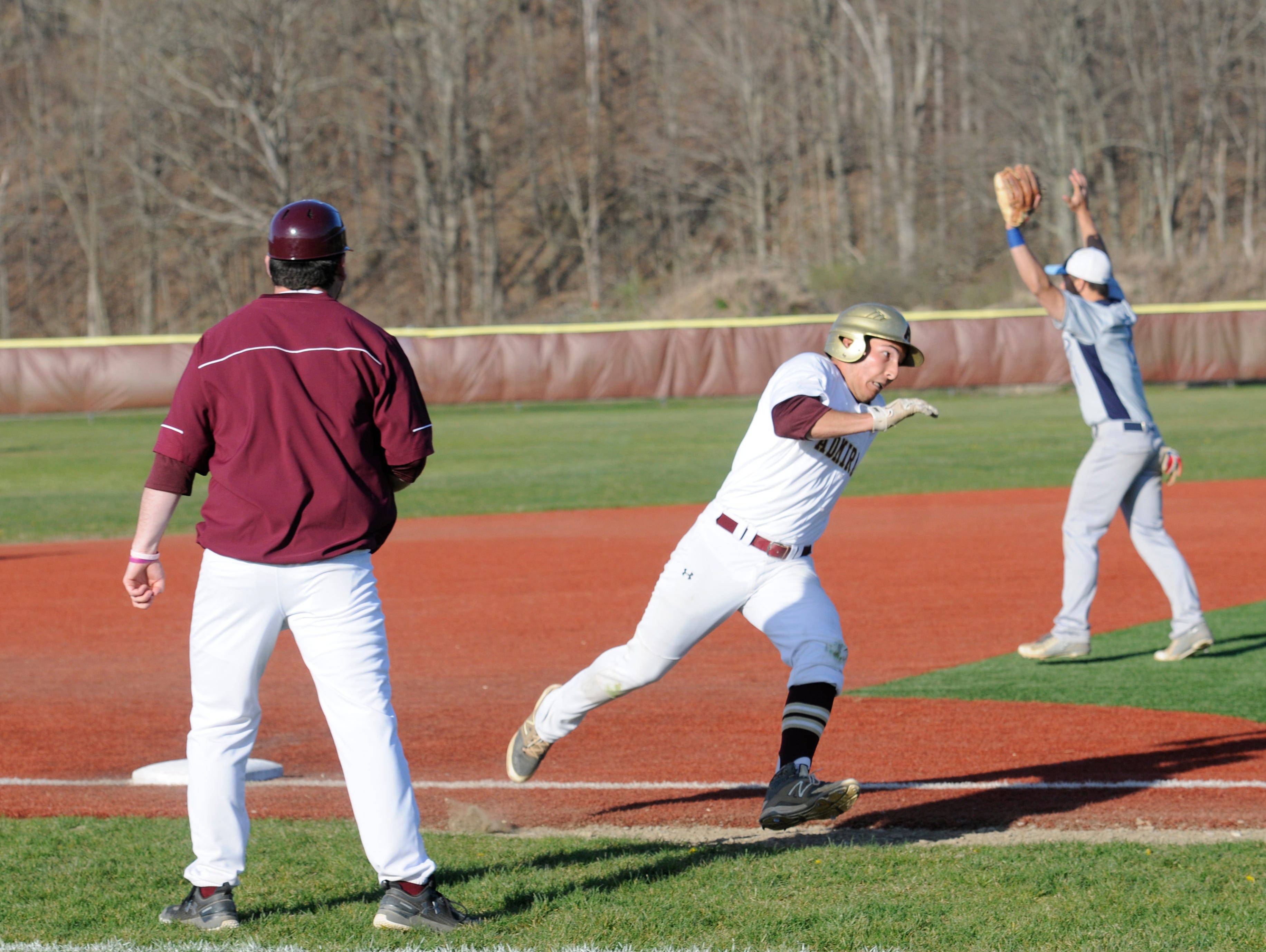 Arlington's Connor Chiulli rounds third base from a single hit by Simon Alvarez to make it home during Tuesday's home game versus John Jay.
