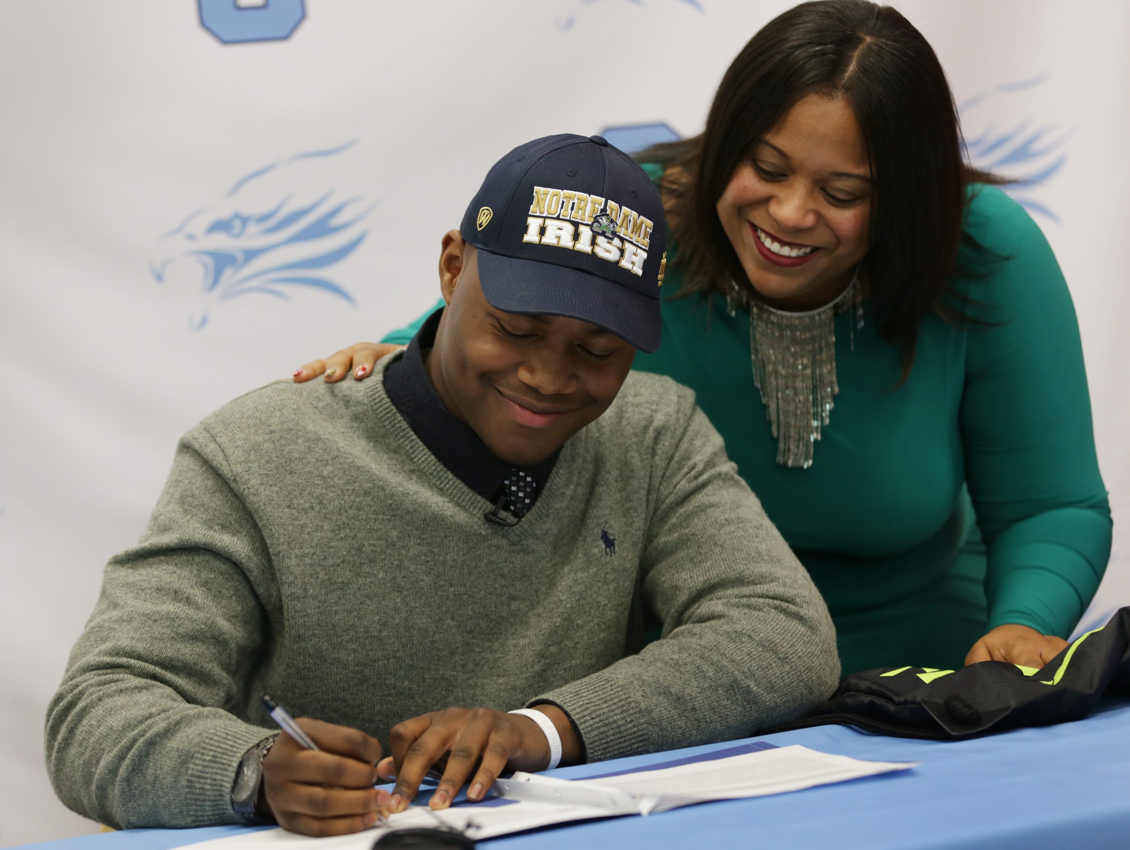 Linebacker Daelin Hayes, left, and his mother, Lakeshia Neal, smile after Hayes committed to Notre Dame at Skyline High School in Ann Arbor on Thursday, Dec. 10, 2015.