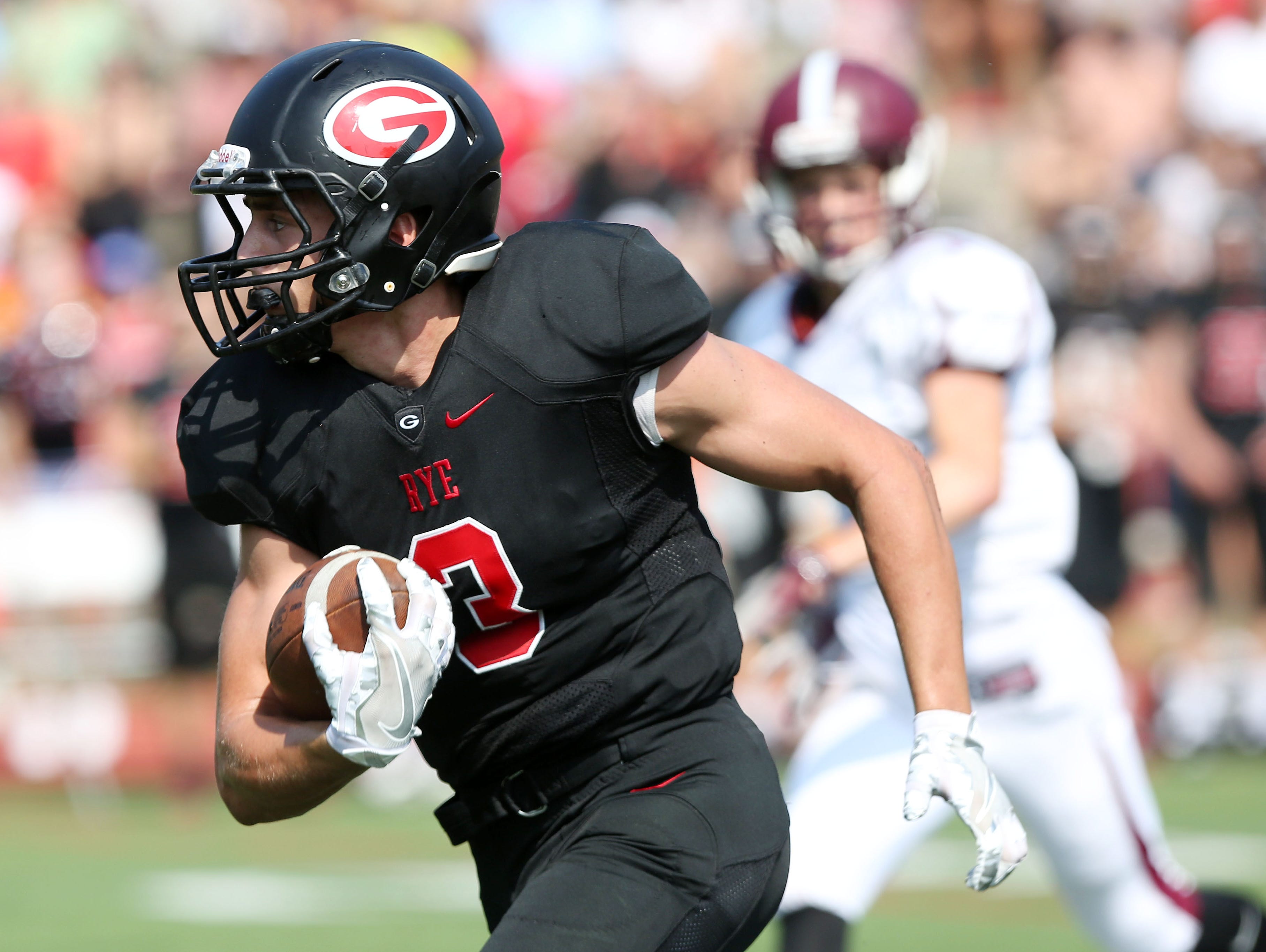 Rye's Matt Bruno (3) catches a pass from teammate TJ Lavelle for Rye's first touchdown of the game against Harrison during the annual rivalry game at Nugent Stadium at Rye High School Sept. 10, 2016. Rye won the game 42-12.