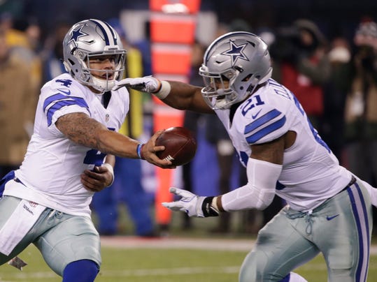 FILE - In this Sunday, Dec. 11, 2016 file photo, Dallas Cowboys quarterback Dak Prescott (4) hands the ball to Ezekiel Elliott (21) during the second half of an NFL football game against the New York Giants in East Rutherford, N.J. Ezekiel Elliott pelted fellow rookie Dak Prescott with straw wrappers and a spitball when the Dallas quarterback was surrounded by reporters, trying to explain how he kept the task of replacing Tony Romo from becoming too big. (AP Photo/Seth Wenig, File)