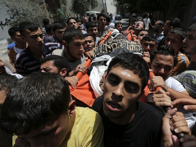 Palestinians carry the body of jihadist Mohammed Sowelim, who was killed in an Israeli airstrike, during his funeral in the Jabaliya refugee camp in northern Gaza on July 12, 2014.