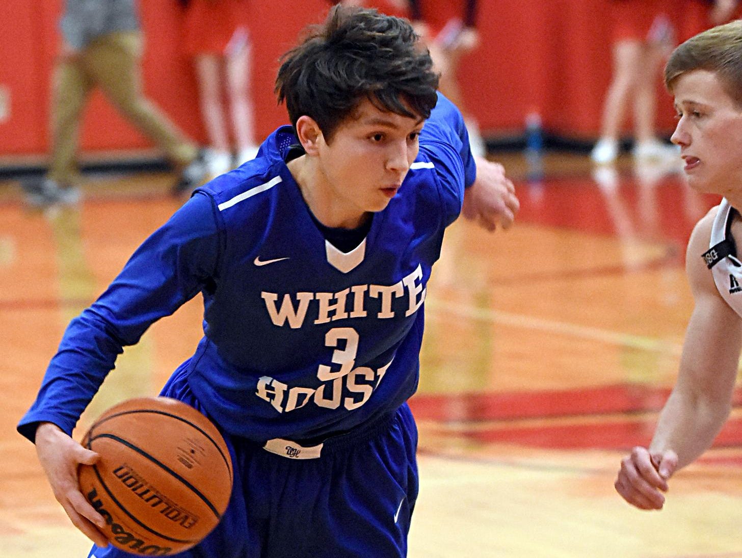 White House High freshman guard Cole Pond dribbles to the basket as Westmoreland senior Landon Dunigan defends.