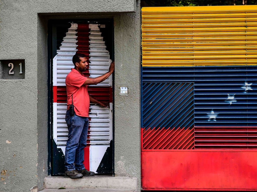 A man stands at the entrance of the house of Venezuelan opposition leader Leopoldo Lopez in Caracas on Aug. 1, 2017, just hours after he was taken away by the intelligence service.\u000dThe Venezuelan intelligence service arrested opposition leaders 