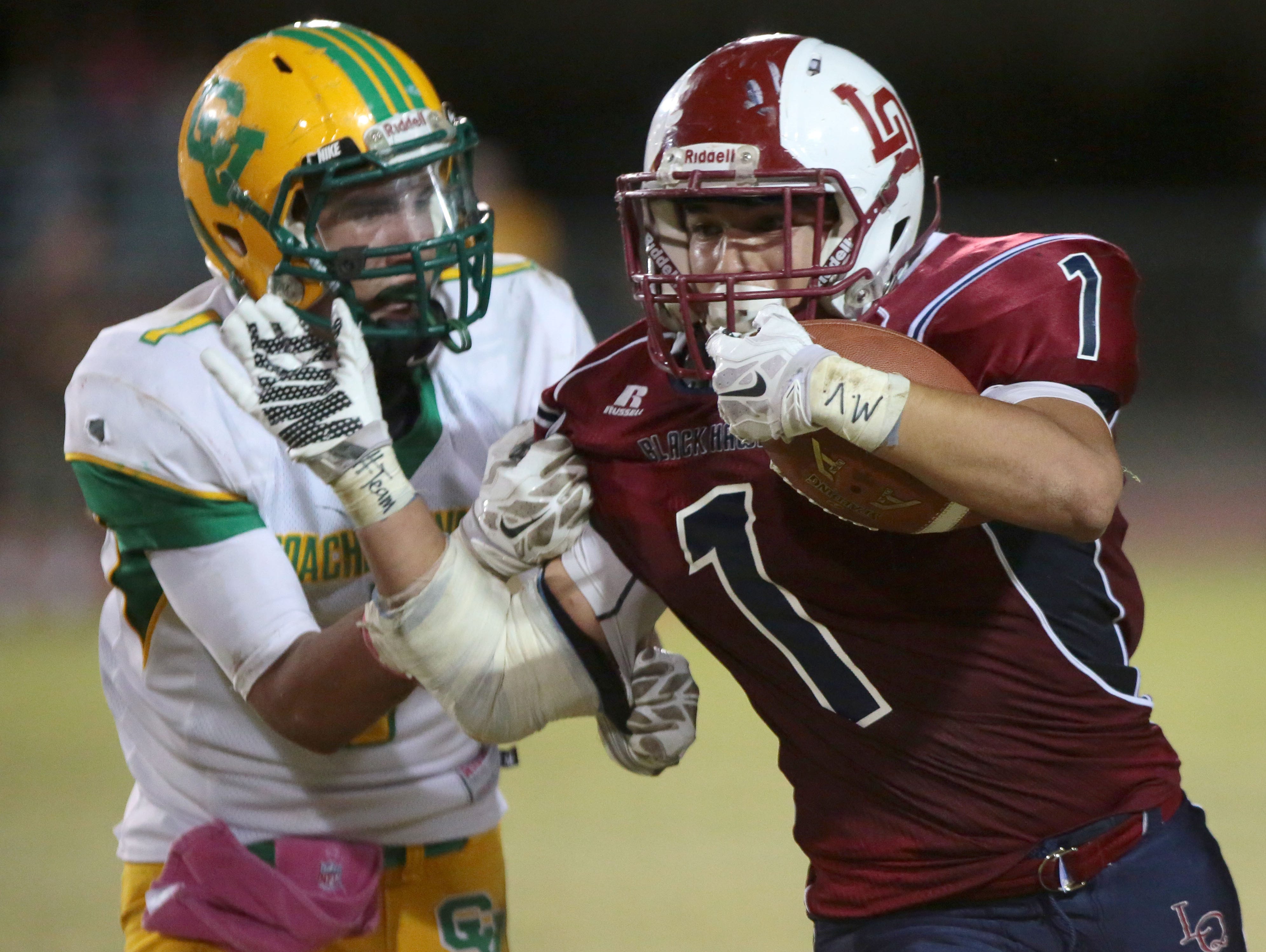 La Quinta's Benji Cordova carries the ball for a first down against Coachella Valley on Friday.