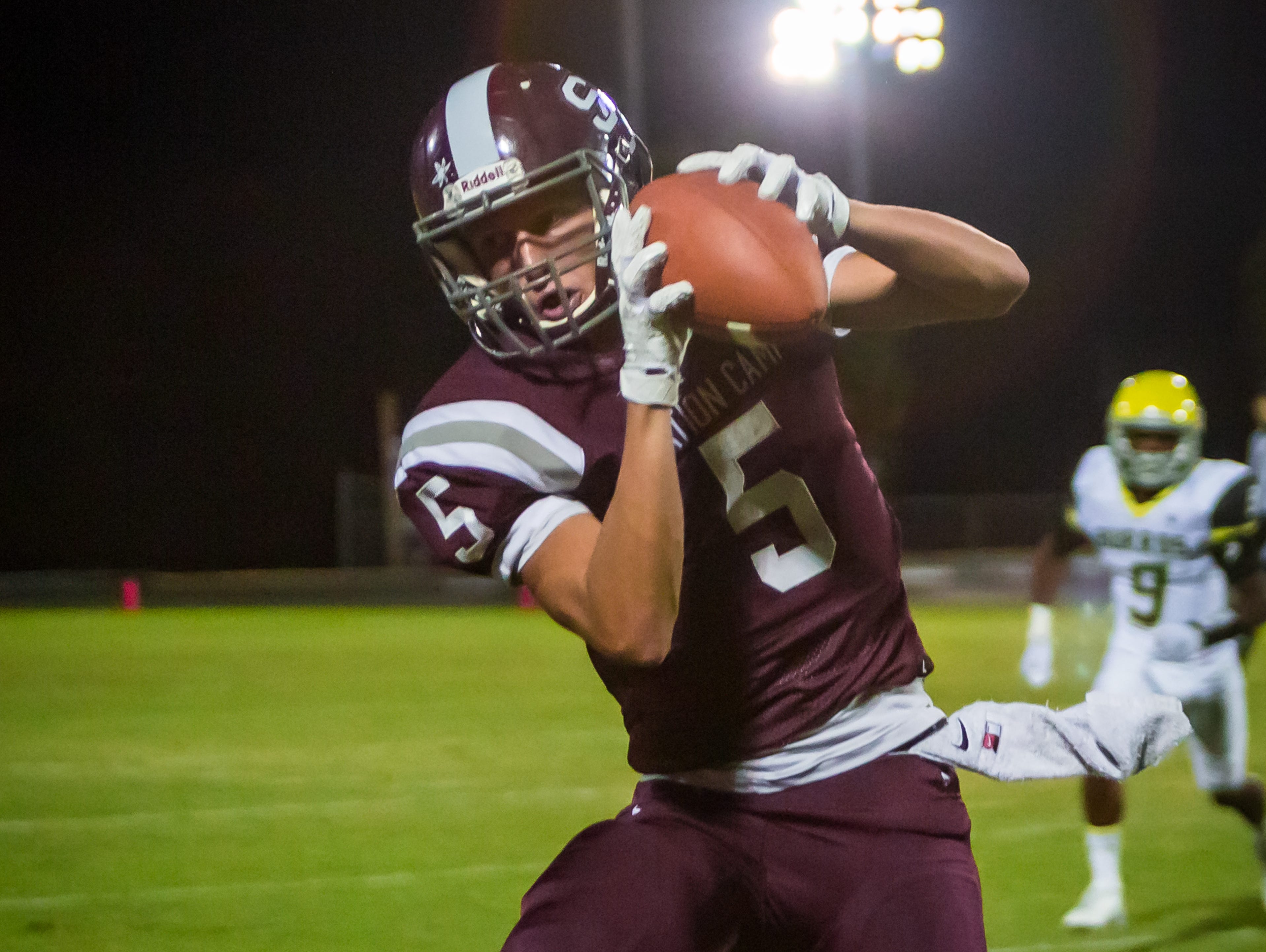 Station Camp senior Jett Frost catches a pass near the sideline during Friday's 42-7 loss to Hillsboro.