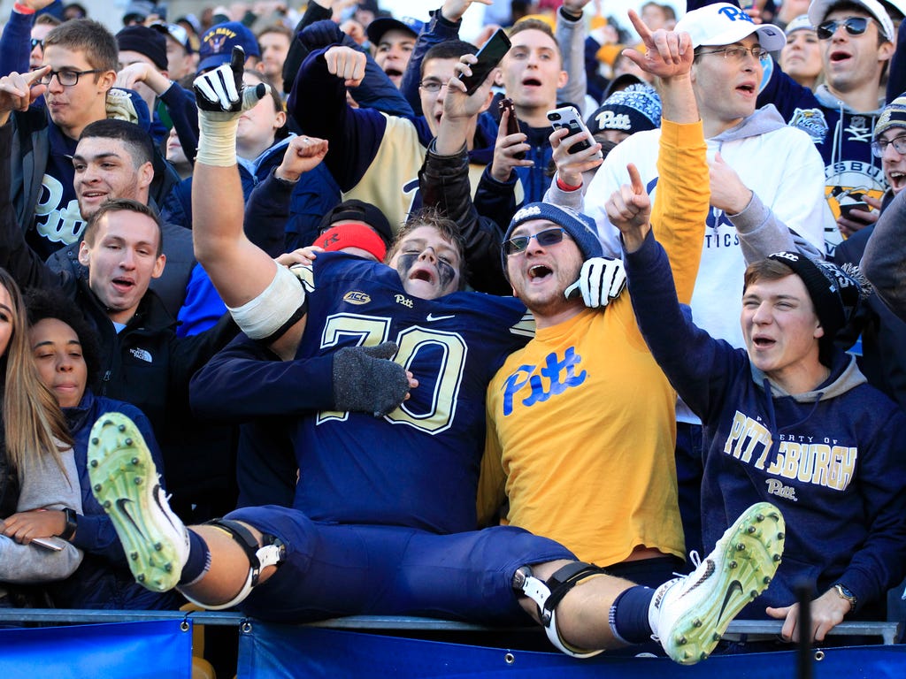 Pittsburgh Panthers offensive lineman Brian O'Neill (70) celebrates in the student section after defeating the Miami Hurricanes at Heinz Field.