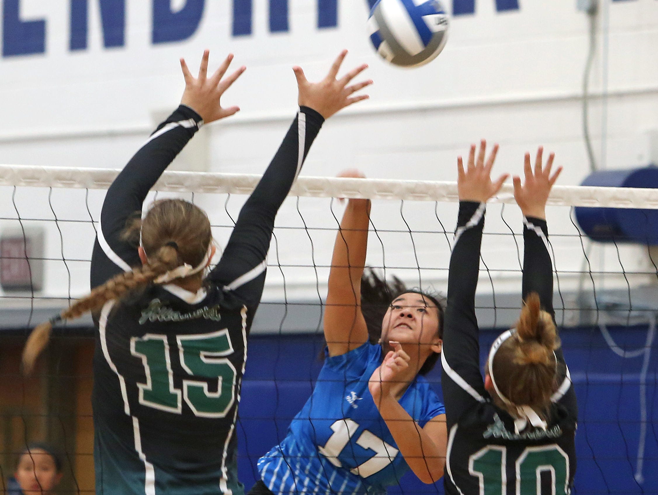 Hendrick Hudson's Kristin Loh (17) gets a shot by Yorktown's Toni Fiore (15) and Macey Dresek (10) during volleyball action at Hendrick Hudson High School in Montrose Sept. 10, 2015. The Sailors took all three games.