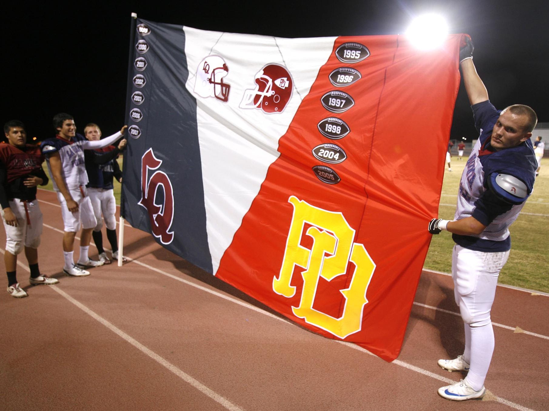11-12-08 cq Chris Ruiz, Andrew Jones, Trent Laddusaw and Ty James La Quinta High School football players hold the La Quinta High School and Palm Desert High School Victory flag. The two teams play November 14. Wade Byars