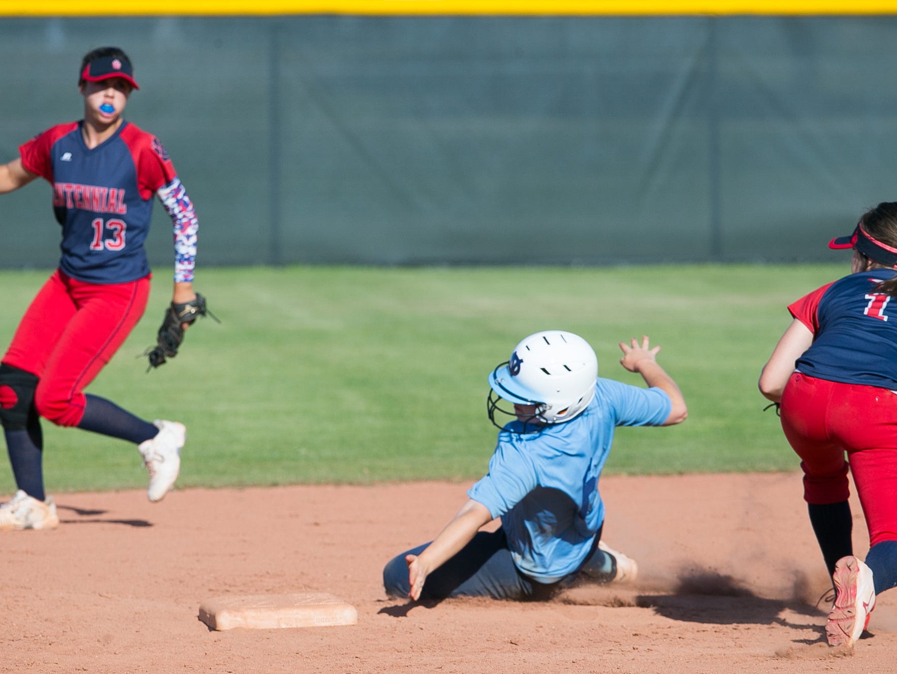 Deer Valley's Marlee Pieper dodges Centennial infielder Skylar McCarty's tag as she steals second base during a game on Thursday, April 14, 2015.