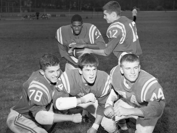 Leon quarterback Billy Sexton (12) hands off in 1966 to running back Leroy Powell, the first African-American to play football for Leon High.