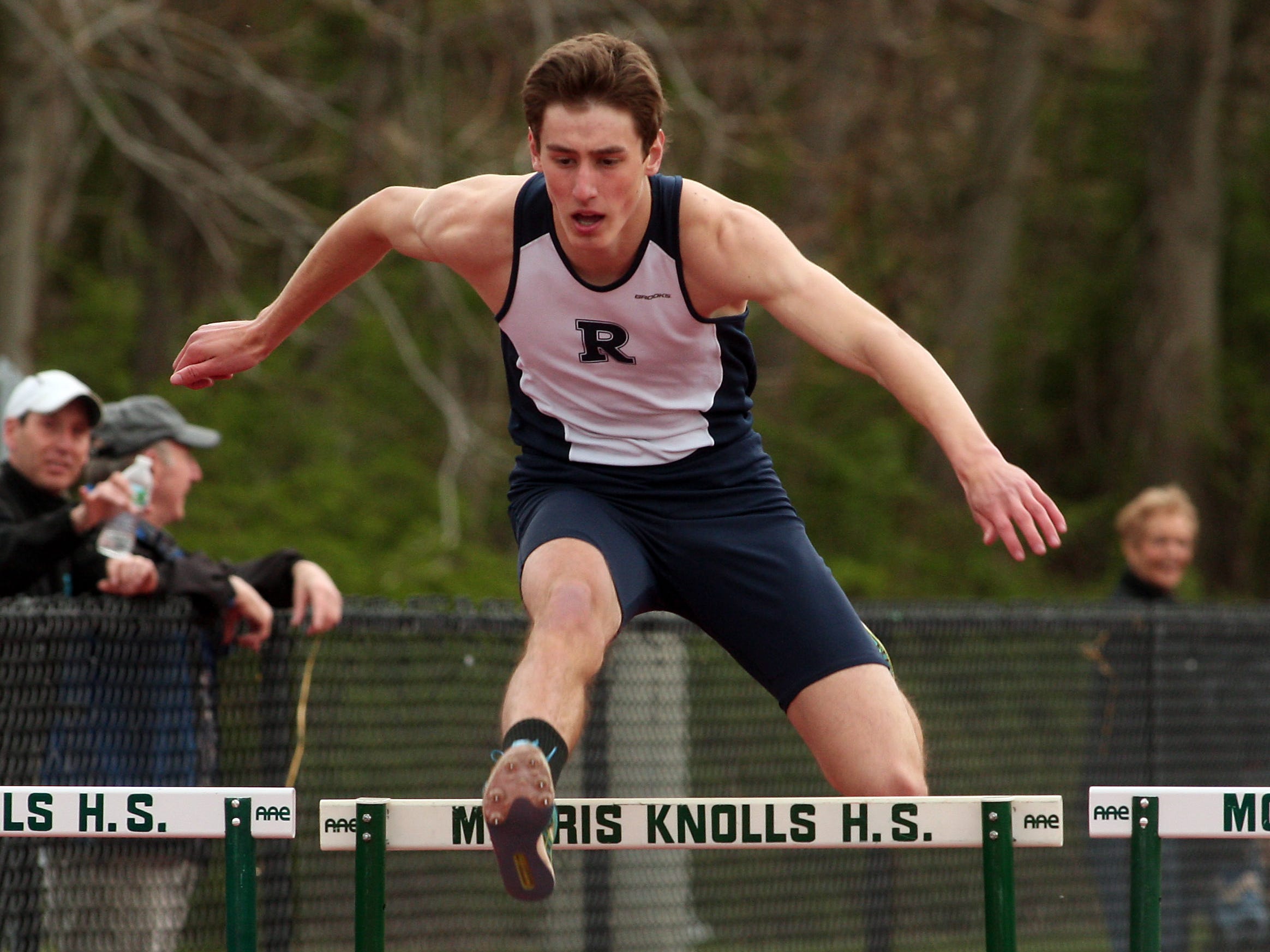 Randolph senior Greg Stickle clears the final hurdle on the first day of the Morris County Relays.