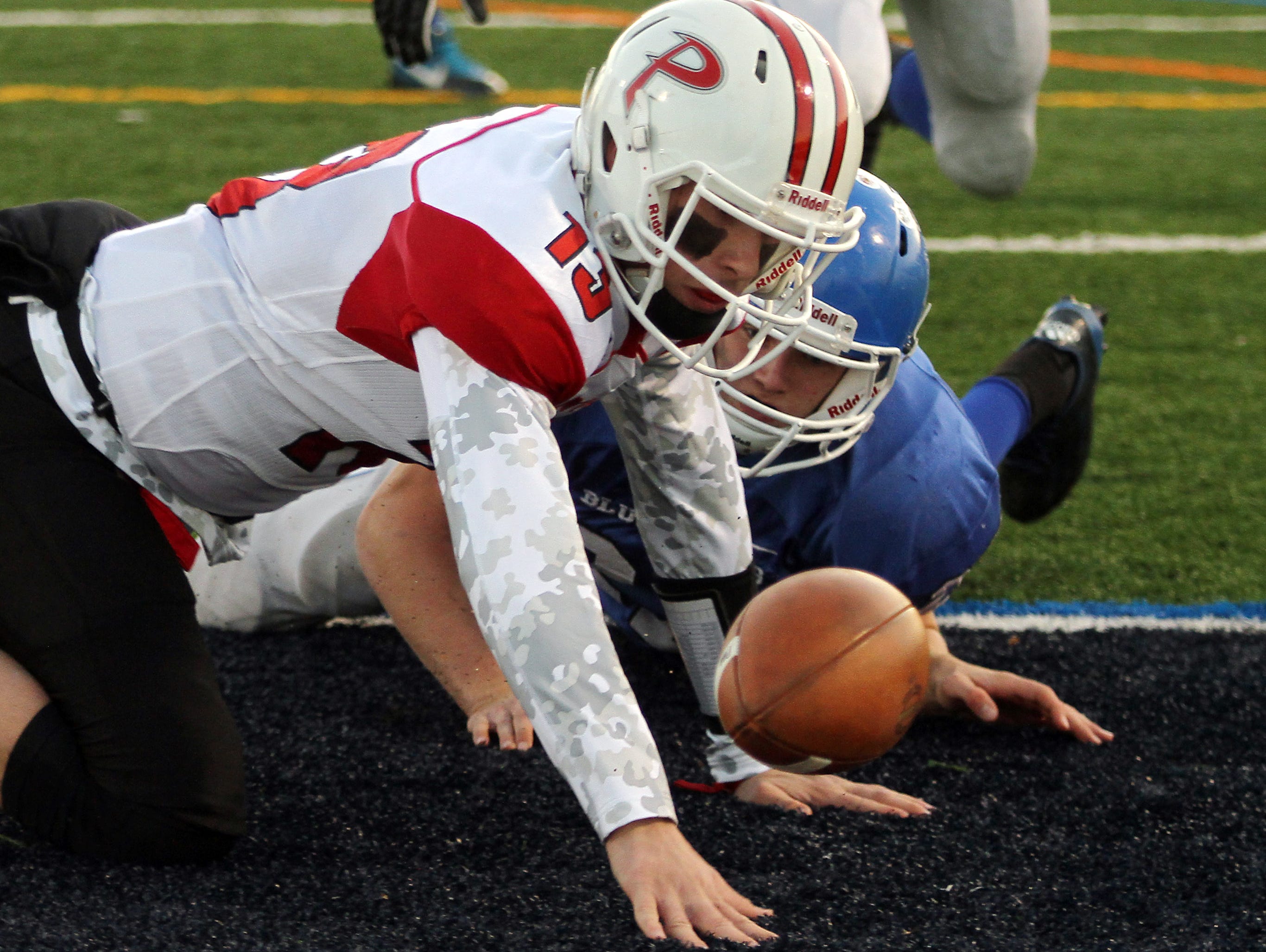 Palmyra quarterback Max Smyth and Shore Regional's Alex Johnson reach for the ball in the end zone after a Smyth fumble. The ball was recovered by Shore for a first half touchdown during the NJSIAA Central, Group 1 Championship game at Kean University Alumni Stadium. December 5, 2015, Union, NJ.