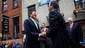 Governor Andrew Cuomo, center, looks on as David Contreras,