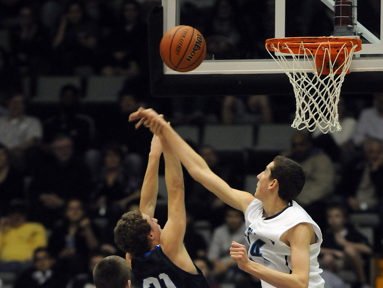Pine Plains' Tyler Lydon blocks a shot by Lake George's Connor McCoy during the Class C state championship game on March 16, 2013 in Glens Falls.