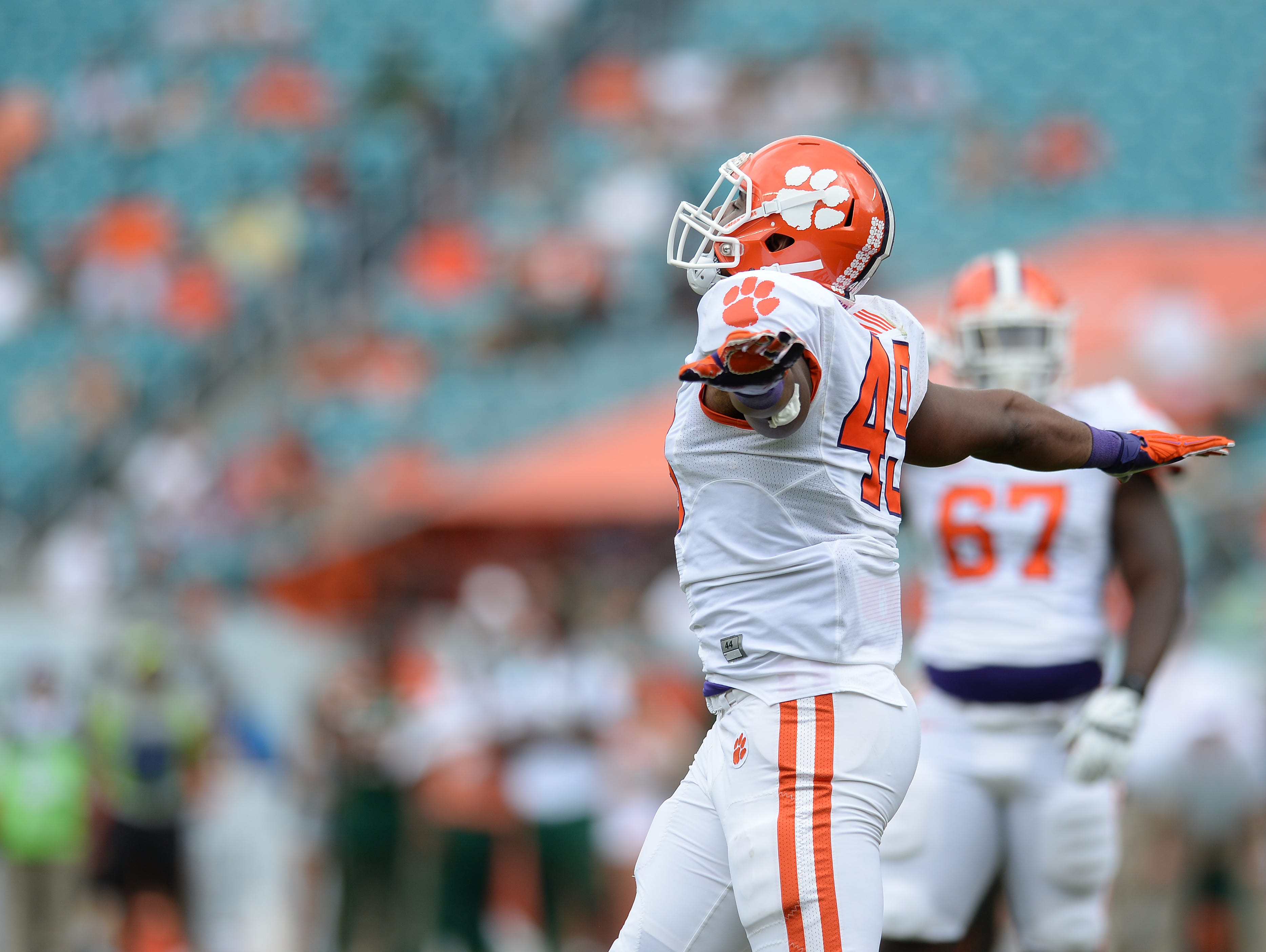 Clemson safety Beau Brown (49) reacts after sacking Miami quarterback Malik Rosier (12) during the 3rd quarter Saturday, Oct. 24, 2015, in Miami Gardens, Fla.