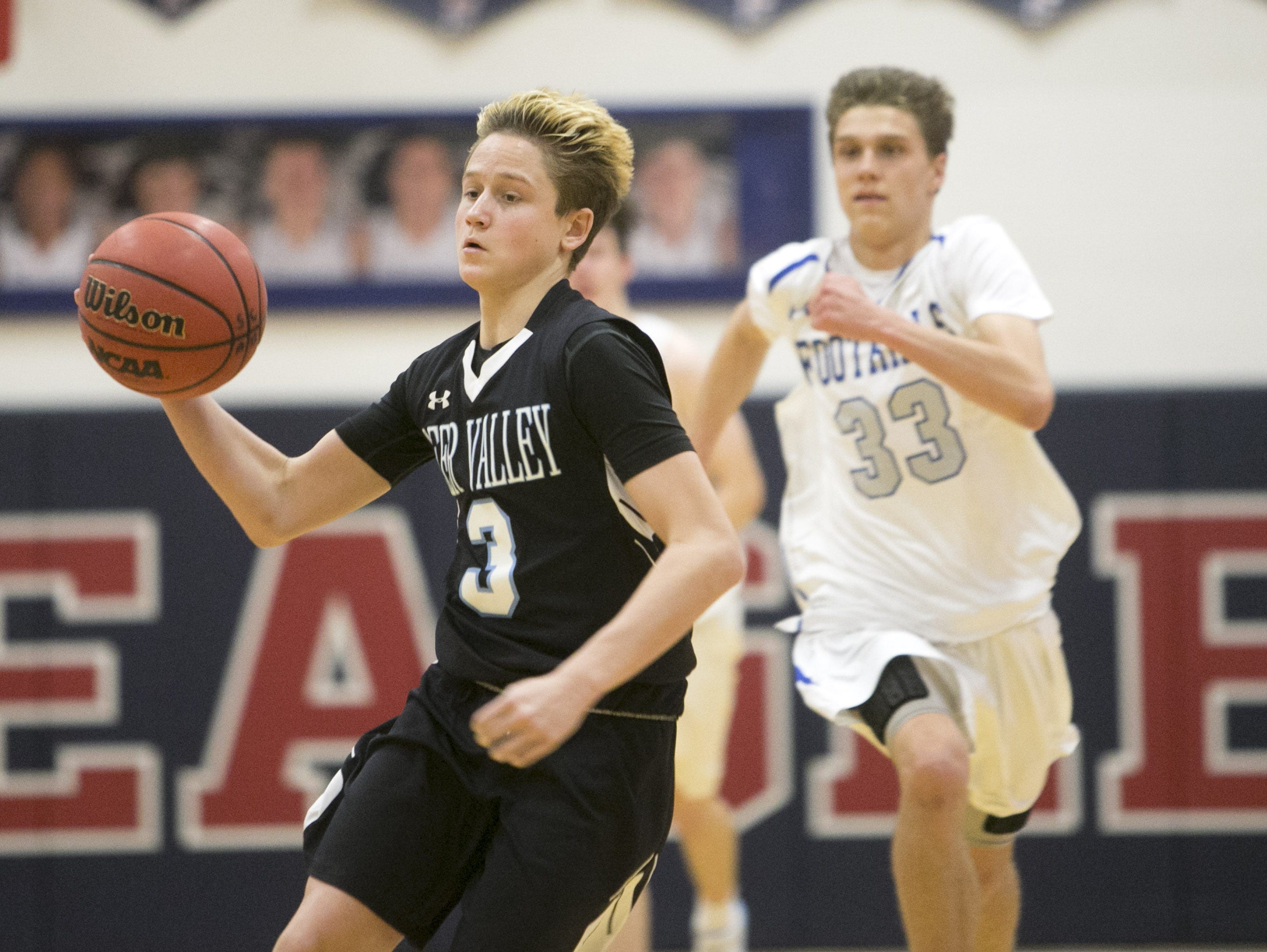 Deer Valley's Deven Breckner dribbles in front of Catalina Foothills' Hayden Moser during the boys basketball game at Scottsdale Christian Academy on Friday, Dec. 30, 2016.