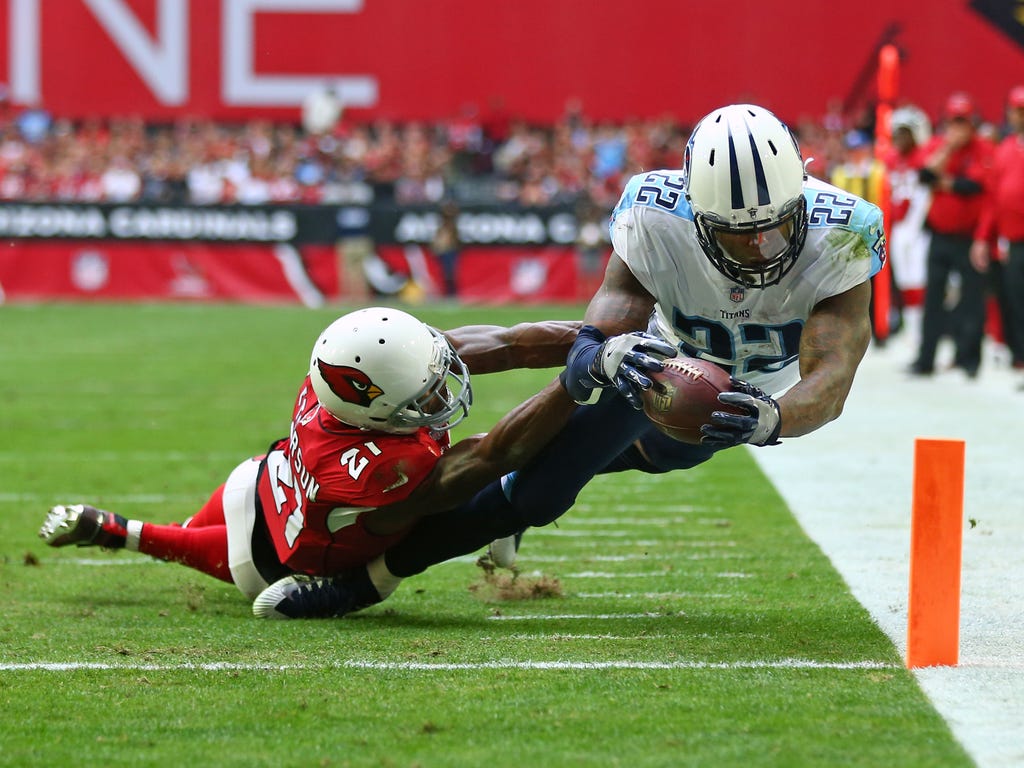 Tennessee Titans running back Derrick Henry dives into the end zone to score a touchdown against Arizona Cardinals cornerback Patrick Peterson in the second quarter at University of Phoenix Stadium in Glendale, Ariz.