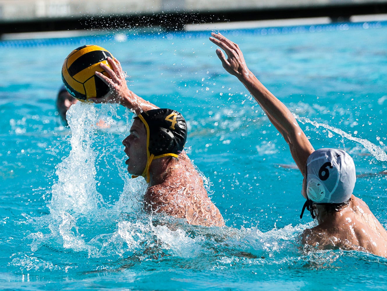 Tulare Union's (4) Blake Lewis swims past Yosemite's Traveis Wood (6).