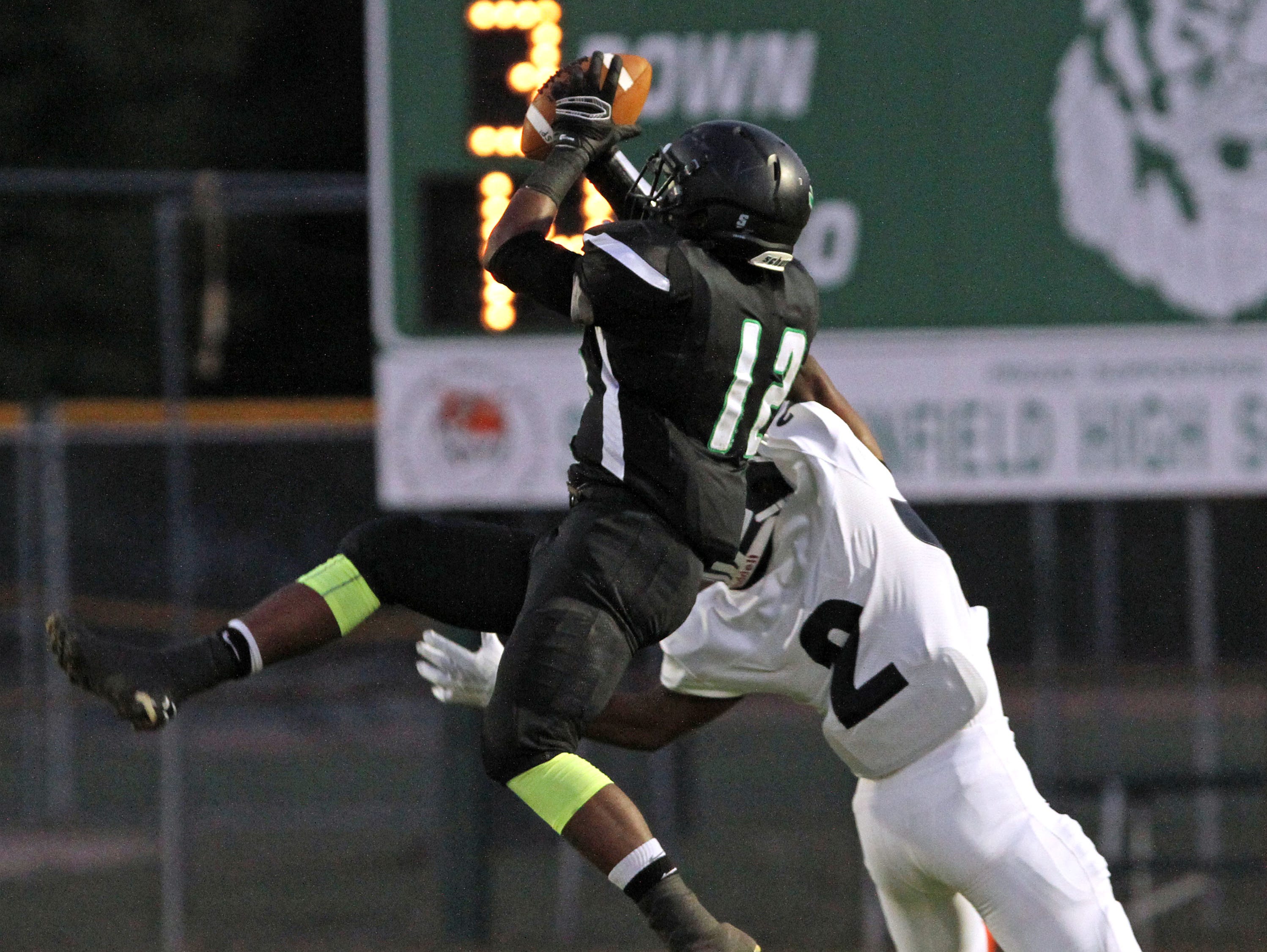 South Plainfield's Jason Lee makes a reception for a loss of yards in football game of New Brunswick at South Plainfield.