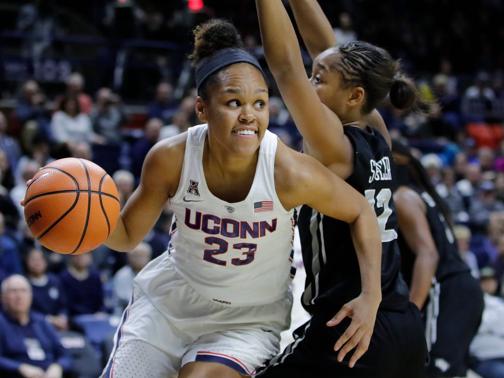 Connecticut Huskies forward Azura Stevens  drives the ball against UCF Knights guard Nyala Shuler in the first half at the XL Center in Storrs, Conn.