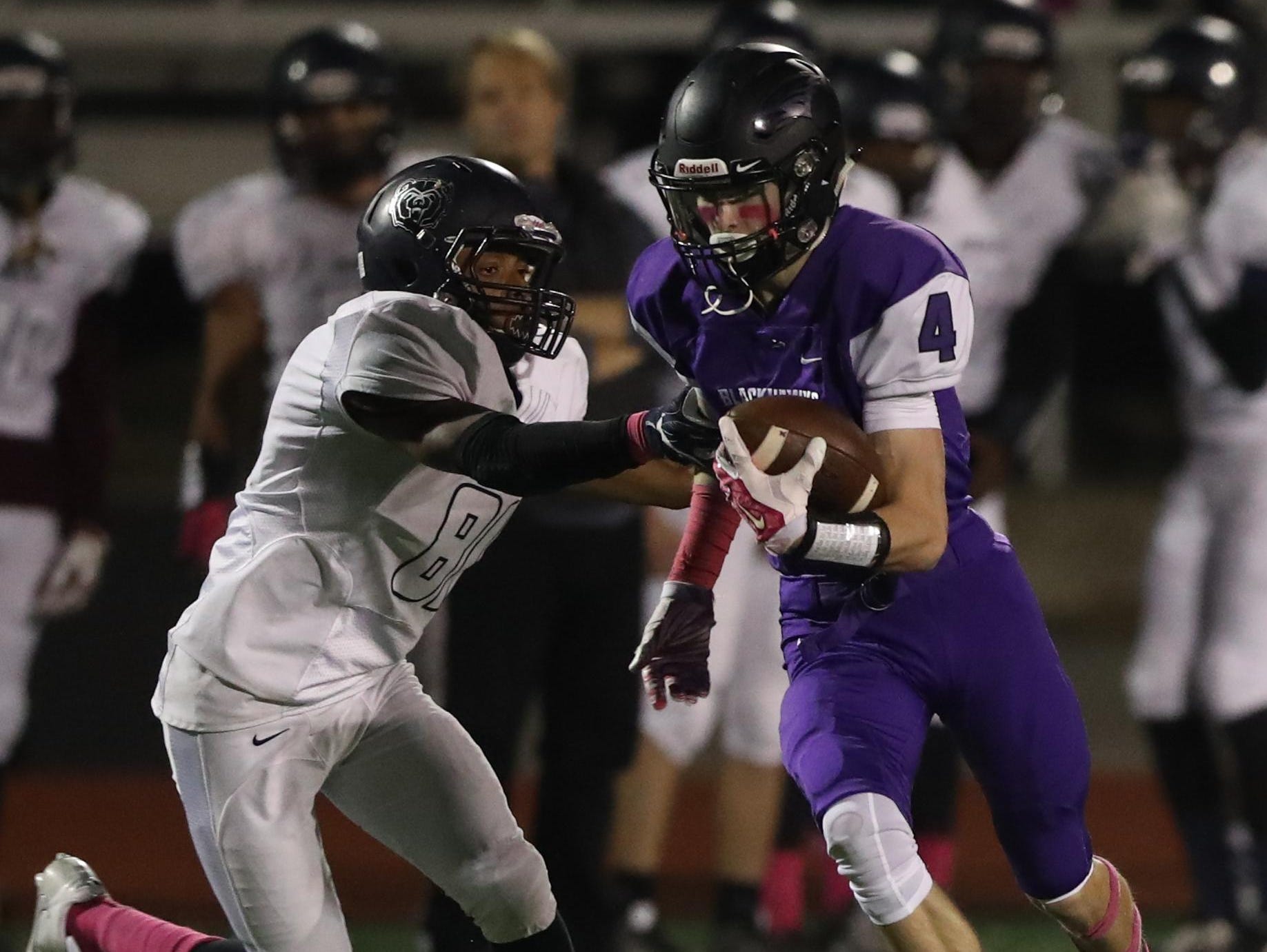 Bloomfield Hills’ Ty Slazinski tries to elude a Berkley defender after catching a pass in Friday night’s game.