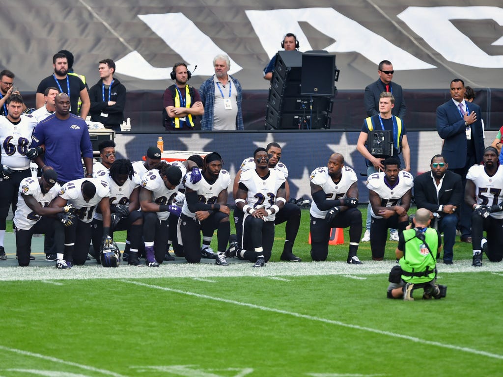 Baltimore Ravens players kneel as the national anthem is played before the game between the Jacksonville Jaguars and the Baltimore Ravens at Wembley Stadium in London on Sept. 24, 2017.