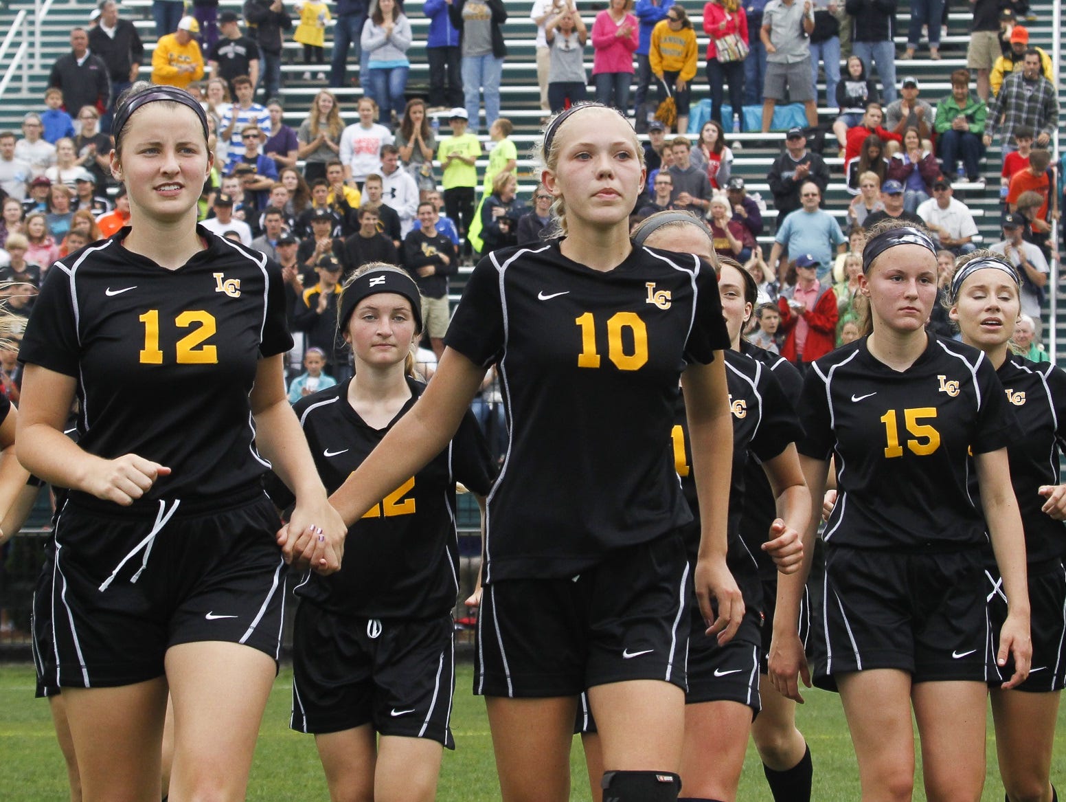Members of the Lansing Christian soccer team walk off the field after losing to Grandville Calvin 2-1 in the Div. 4 state final last season. The No. 1-ranked Pilgrims are looking to get back to the state tournament on Friday.