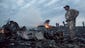 People walk through the debris at the crash site.