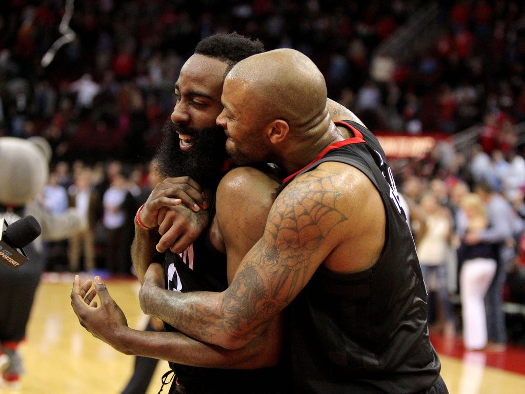 The Houston Rockets' James Harden is congratulated by teammate PJ Tucker following Houston's 114-107 victory over the Orlando Magic. Harden finished the game with a career- and franchise-high 60 points.