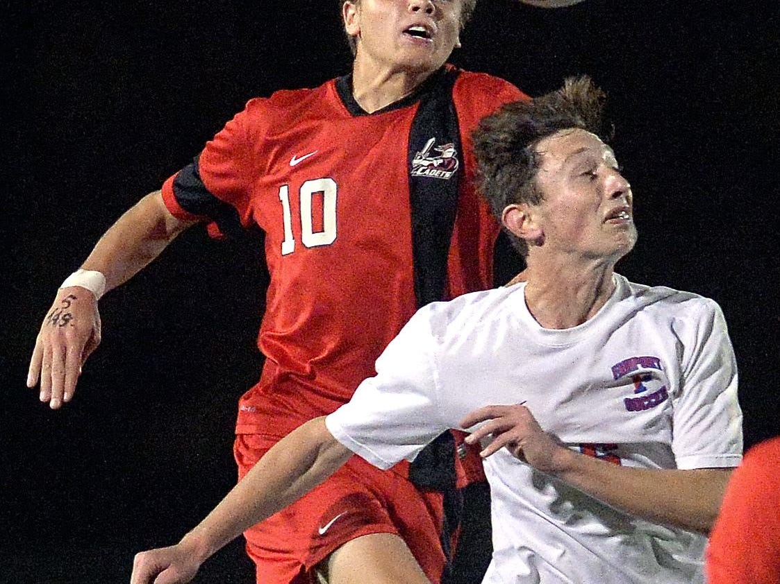 Fairport’s Nick Guida, right, and Hilton’s Simon Garno jump for a header.