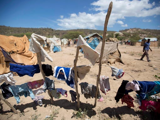Clothes hang to dry in a camp set up by Haitians who