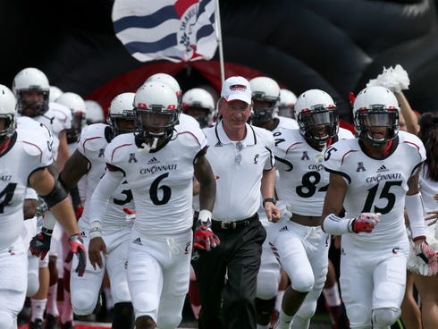 University of Cincinnati head coach Tommy Tuberville leads his team onto the field against Purdue at Nippert Stadium.