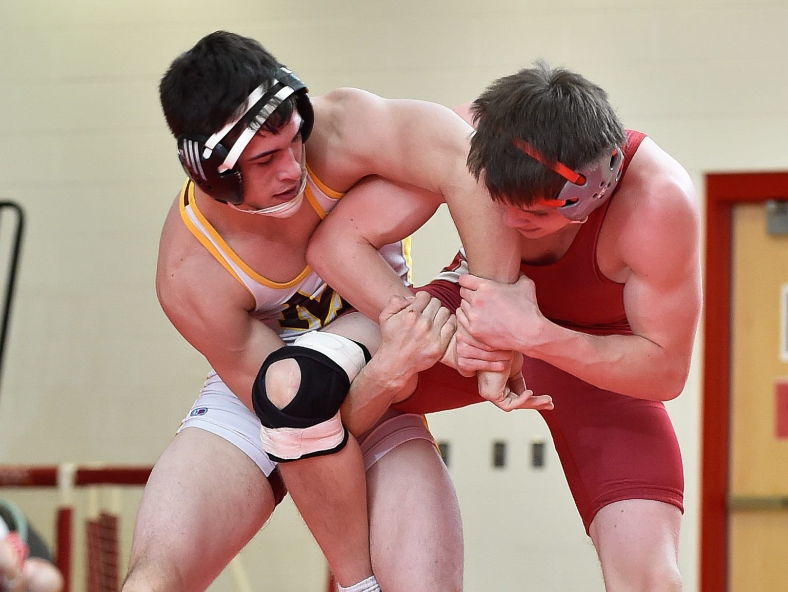 Milford's Barton Dalious, left and Smyrna's Tanner Mullen in the 145 pound match at Smyrna High School.
