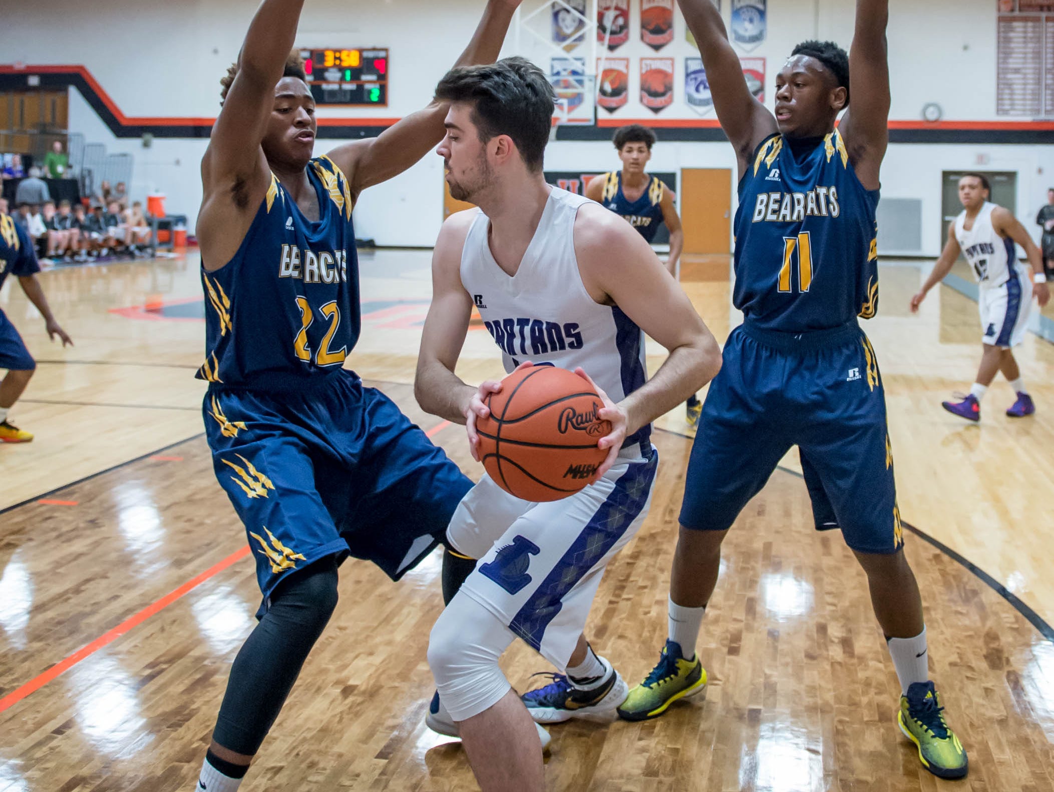 Lakeview's Jared Fisk (44) gets traped by Battle Creek Central's Juan Warren (22) and Demetrius Craif (11) Wednesday night.