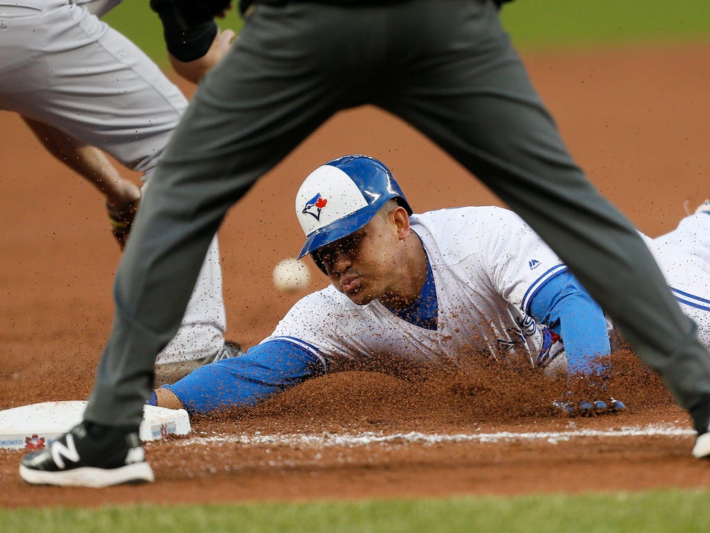 Toronto Blue Jays left fielder Ezequiel Carrera (3) steals third base against the New York Yankees in the second inning at Rogers Centre.