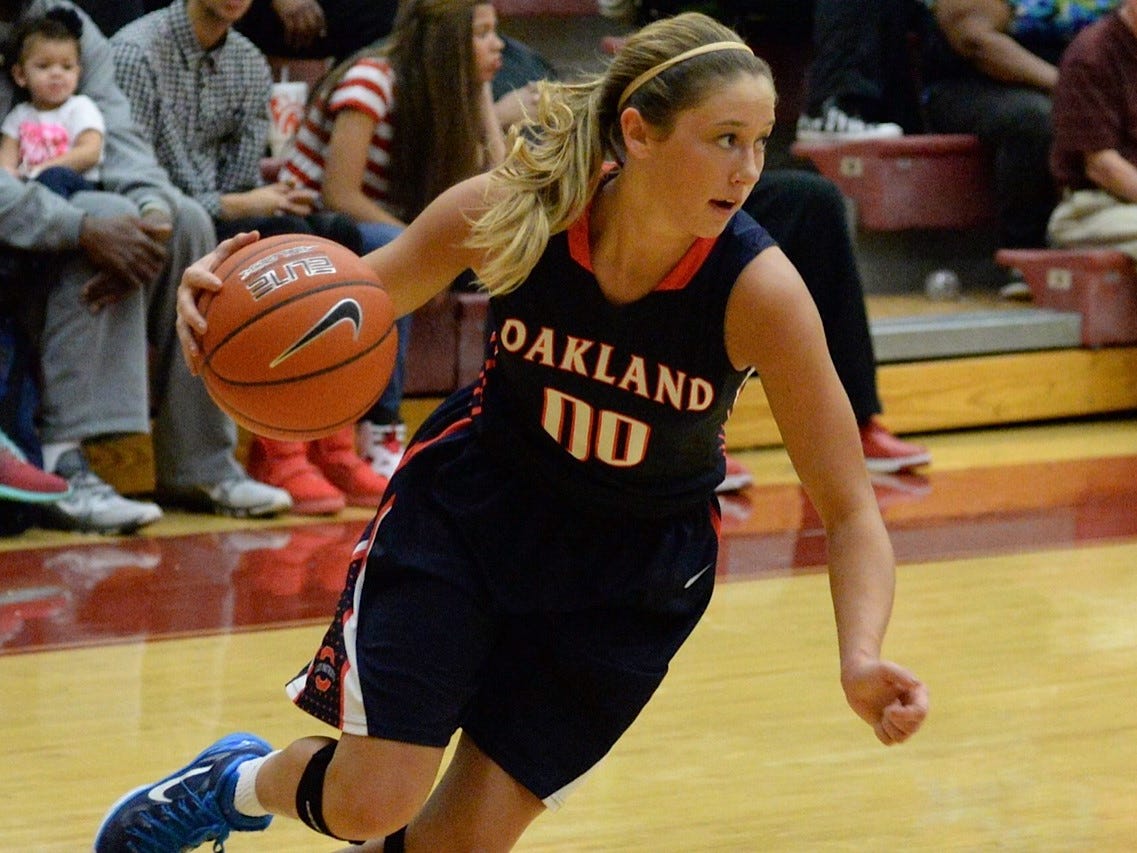 Oakland guard Ansley Eubank (00) drives to the basket against Riverdale during the District 7-AAA tournament at Riverdale Saturday night.
