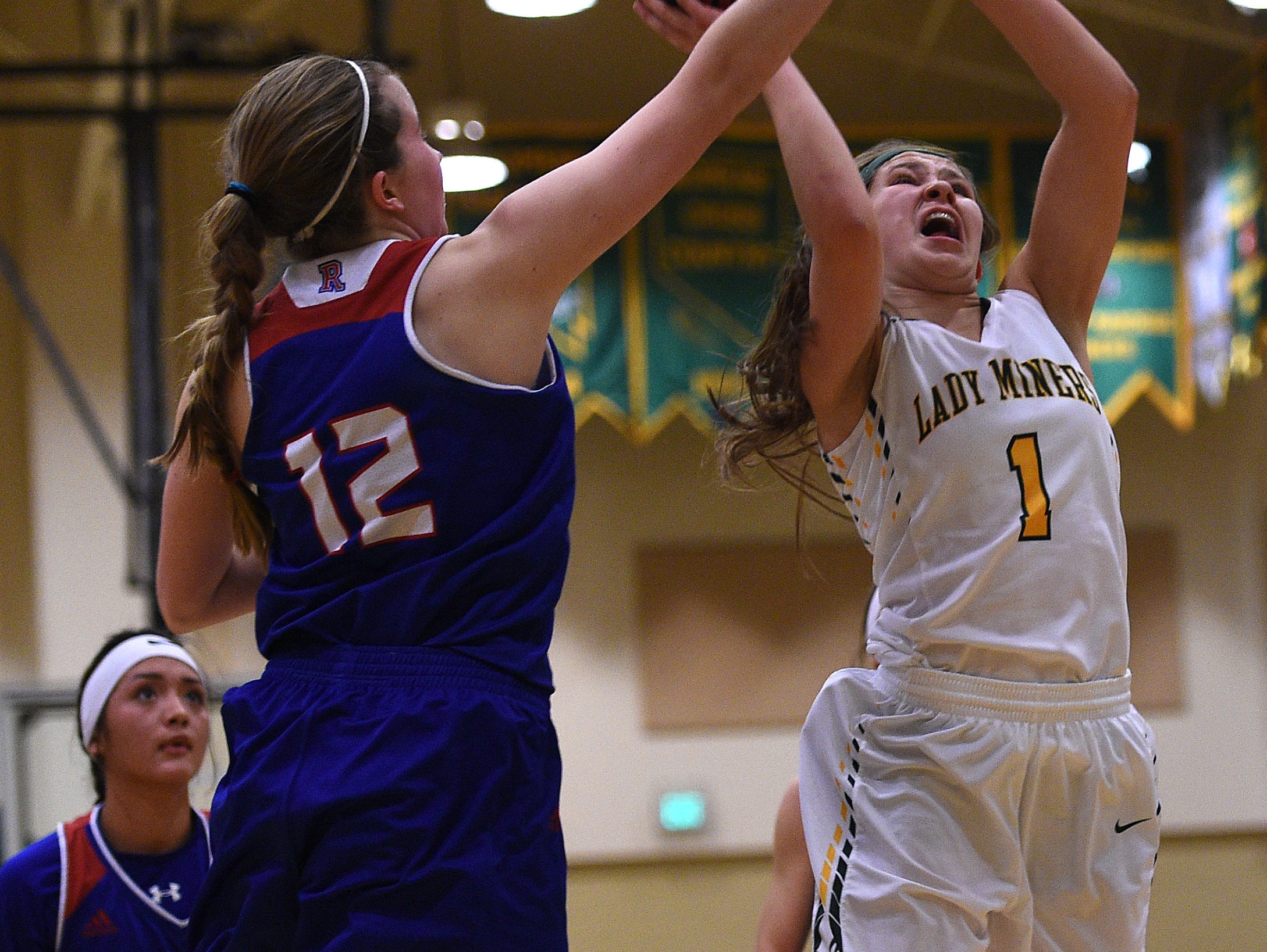 Bishop Manogue's Katie Turner (1) drives against Reno's Mia Wilmot (12) during their basketball game at Manogue on Friday