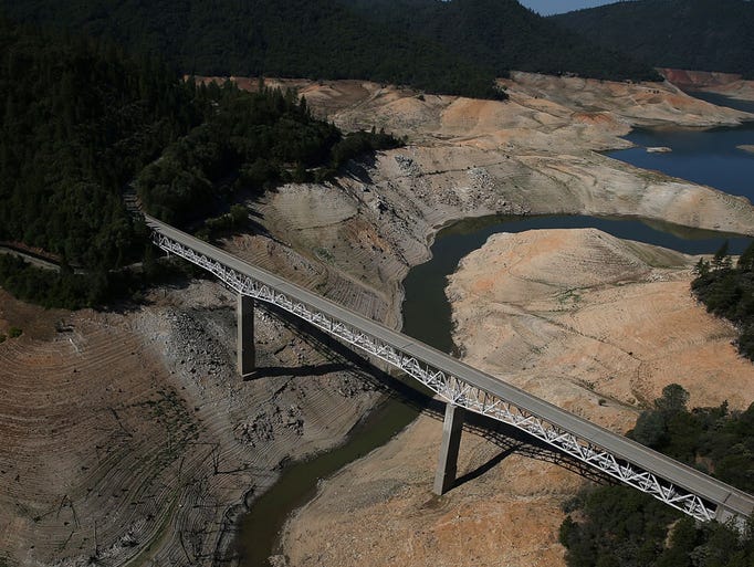 The Enterprise Bridge passes over a section of Lake Oroville that is nearly dry on August 19, 2014 in Oroville, California. As the severe drought in California continues for a third straight year, water levels in the State's lakes and reservoirs is reaching historic lows