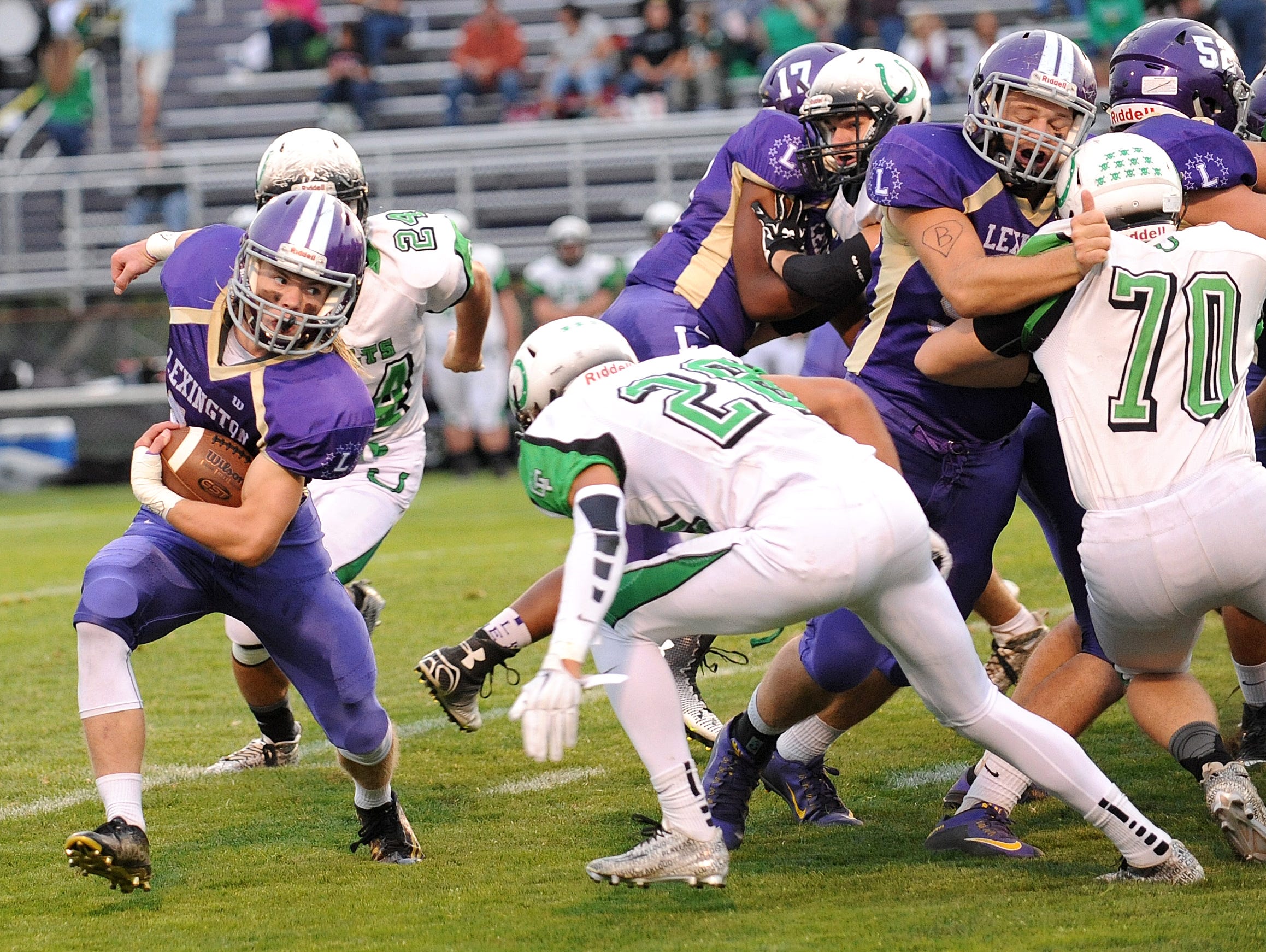 Lexington's Jakob Goettel runs the ball Friday night during their game against Clear Fork.