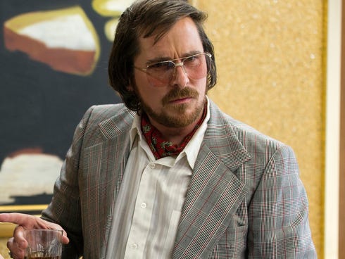 Irving Rosenfeld (Christian Bale) attempts to scam an under cover agent in a scene from the motion picture 