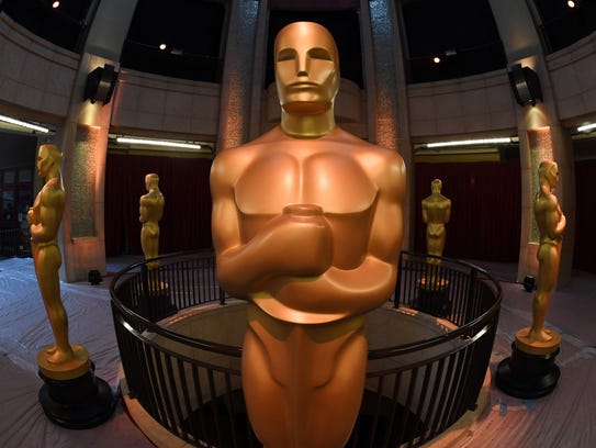 An Oscars statue stands at the end of the red carpet